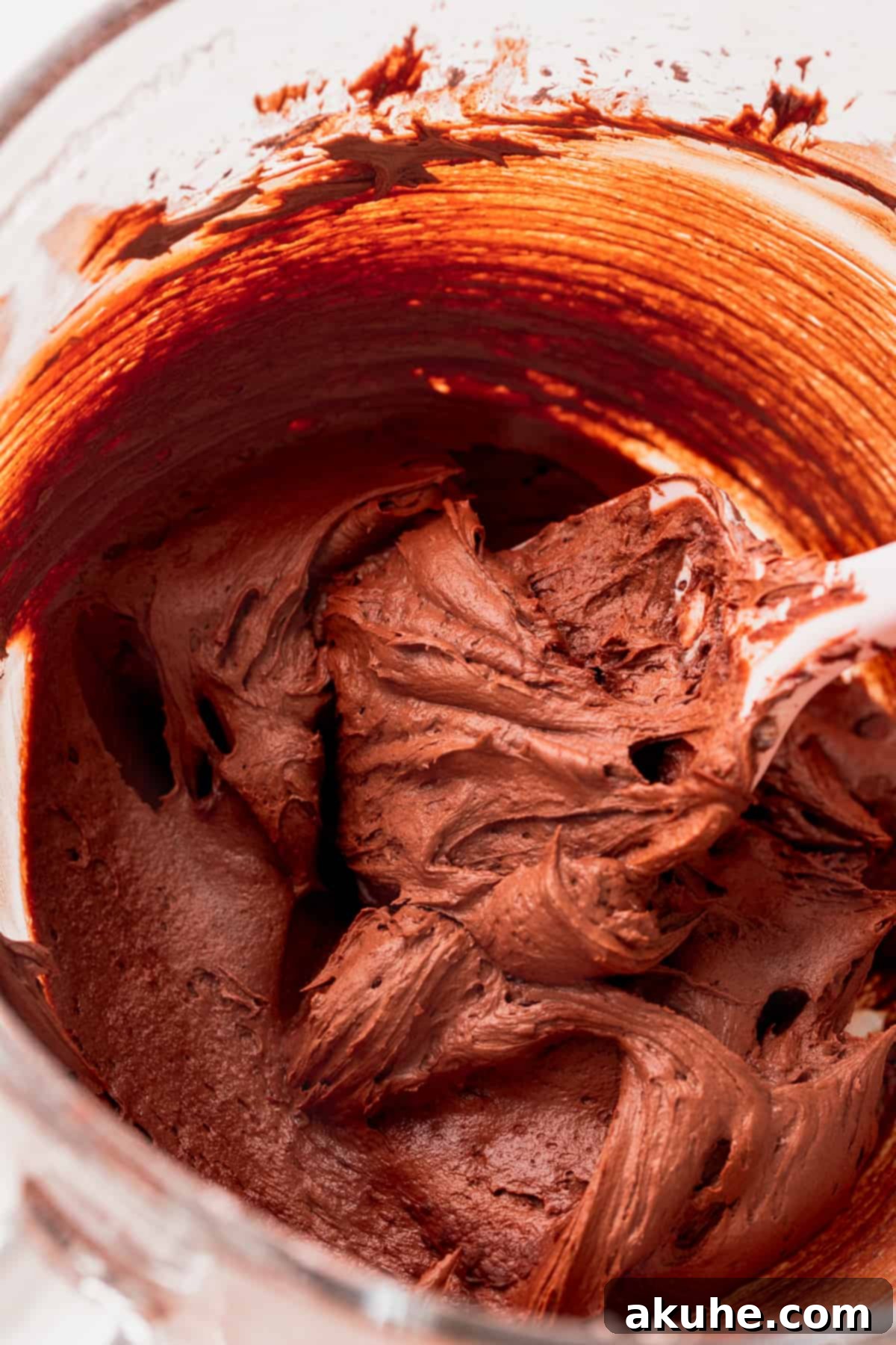Lush chocolate cream cheese frosting in a glass bowl, ready for cake.