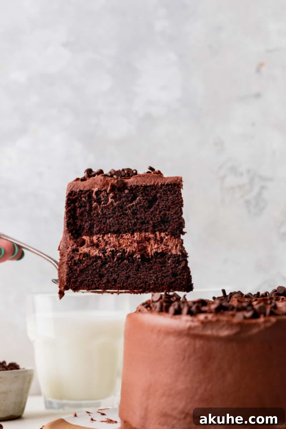 A slice of mini chocolate cake being pulled out, showcasing its layers.