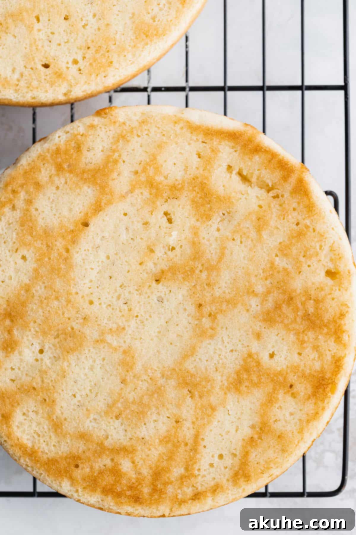 Elegantly Undressed Strawberry Cake 5 Vanilla cake layers on cooling rack.