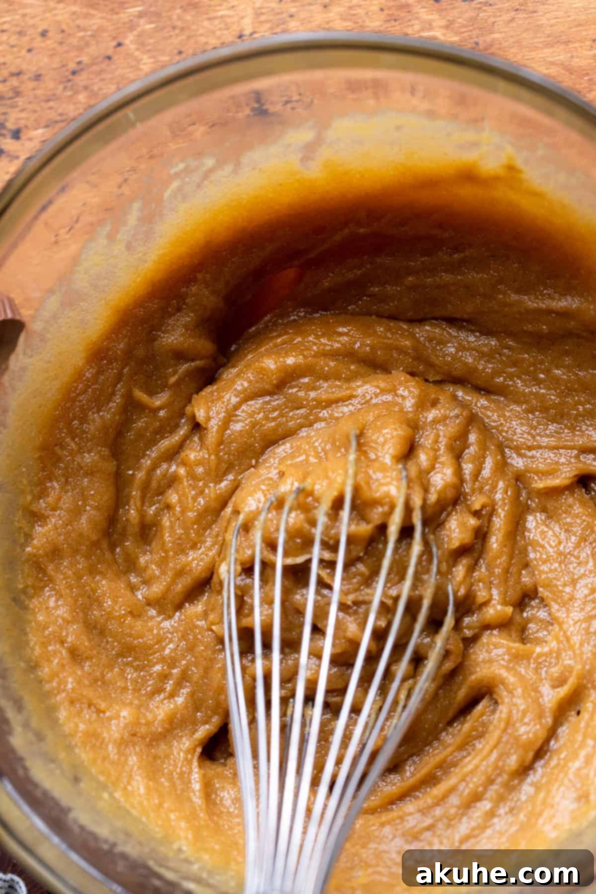 Ultimate Reese's Peanut Butter Chip Cookies 4 Wet ingredients for cookies in a clear glass mixing bowl, perfectly combined.