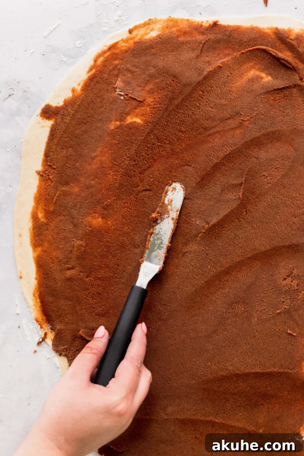Colossal Cinnamon Buns 9 Spreading the cinnamon filling on top of dough.