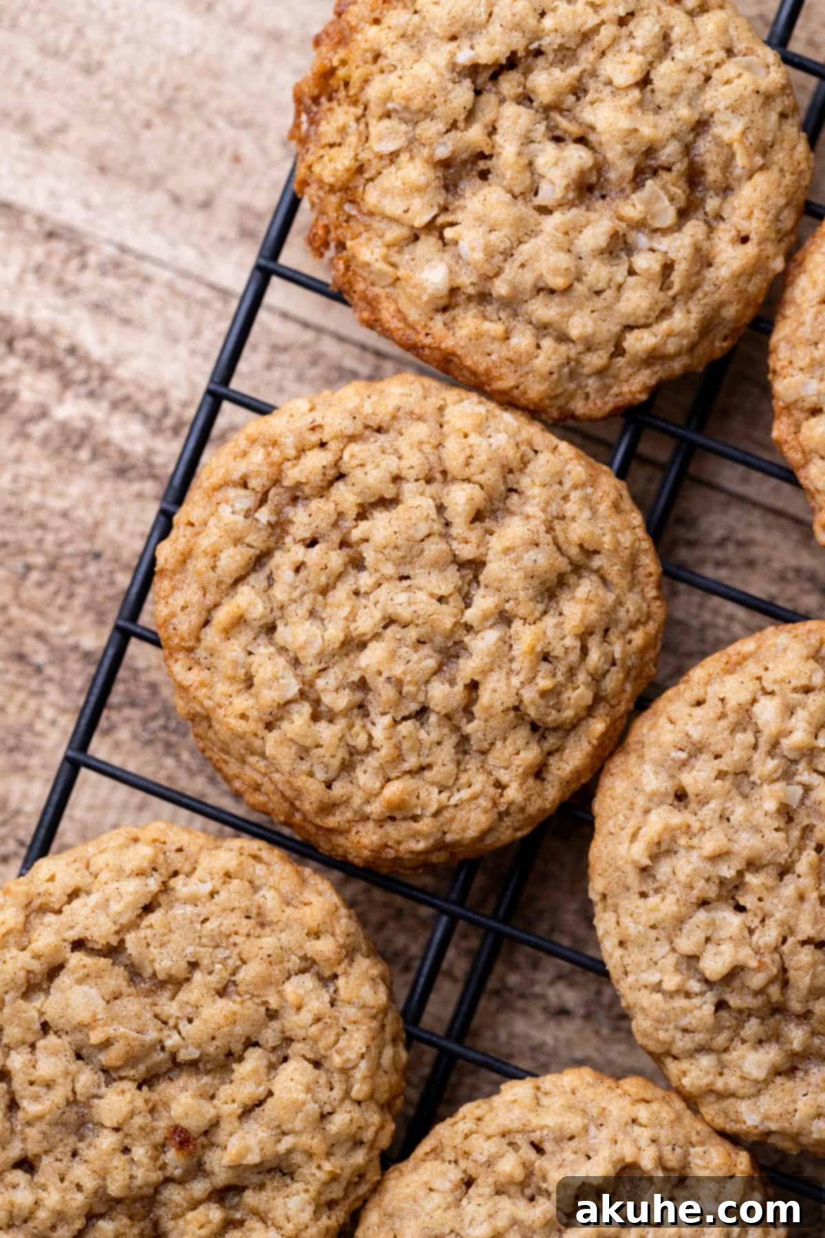 Classic Oatmeal Cream Cookies 7 A freshly baked oatmeal cookie cooling on a wire rack.
