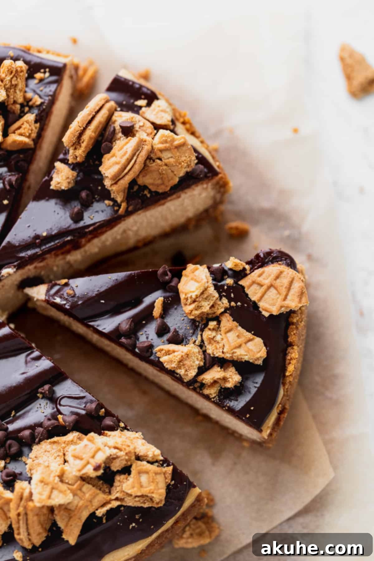 A stunning peanut butter cheesecake cut into perfect slices, with one slice elegantly pulled away from the main cake.