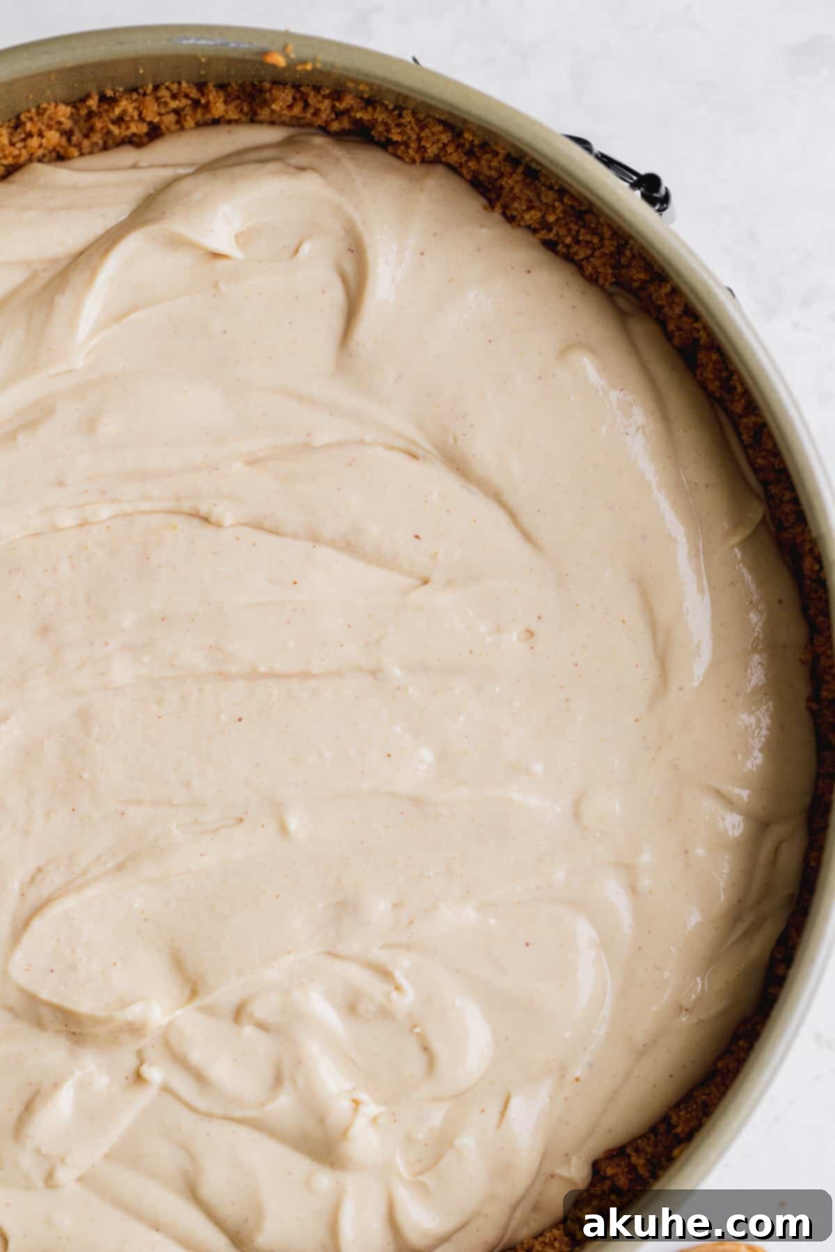 Peanut butter cheesecake batter poured into the springform pan, ready for baking.