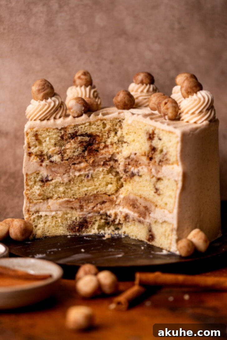 Golden Cinnamon Swirl Cake 2 Snickerdoodle cake split open on a wood board, showcasing the cinnamon swirls and cookie dough filling.