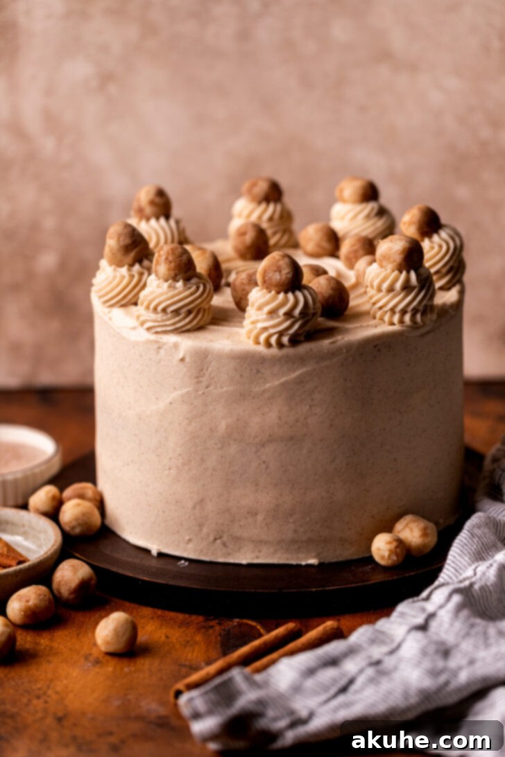 Golden Cinnamon Swirl Cake 13 A fully decorated Snickerdoodle Cake on a wooden serving board, showcasing piped details.