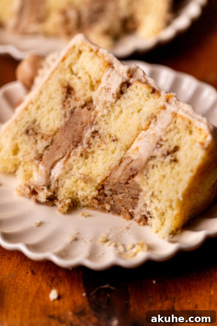 Golden Cinnamon Swirl Cake 15 A slice of Snickerdoodle Cake with a bite taken out, highlighting its deliciousness and inviting texture.