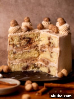 Golden Cinnamon Swirl Cake 16 Snickerdoodle cake split open on a wood board, a close-up of the delicious layers.