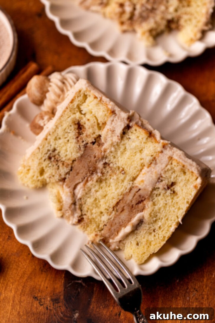 Golden Cinnamon Swirl Cake 3 A perfectly sliced piece of Snickerdoodle Cake on a white plate, ready to be enjoyed.