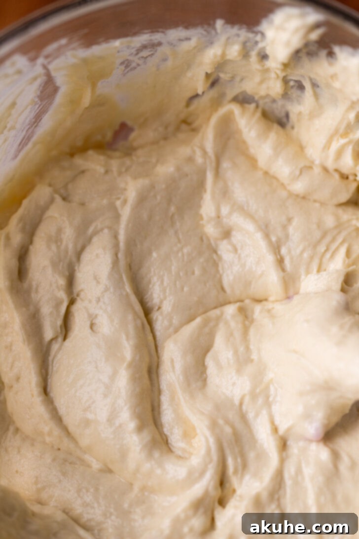 Golden Cinnamon Swirl Cake 5 Smooth, well-mixed cake batter in a large mixing bowl, ready for the cinnamon swirl.