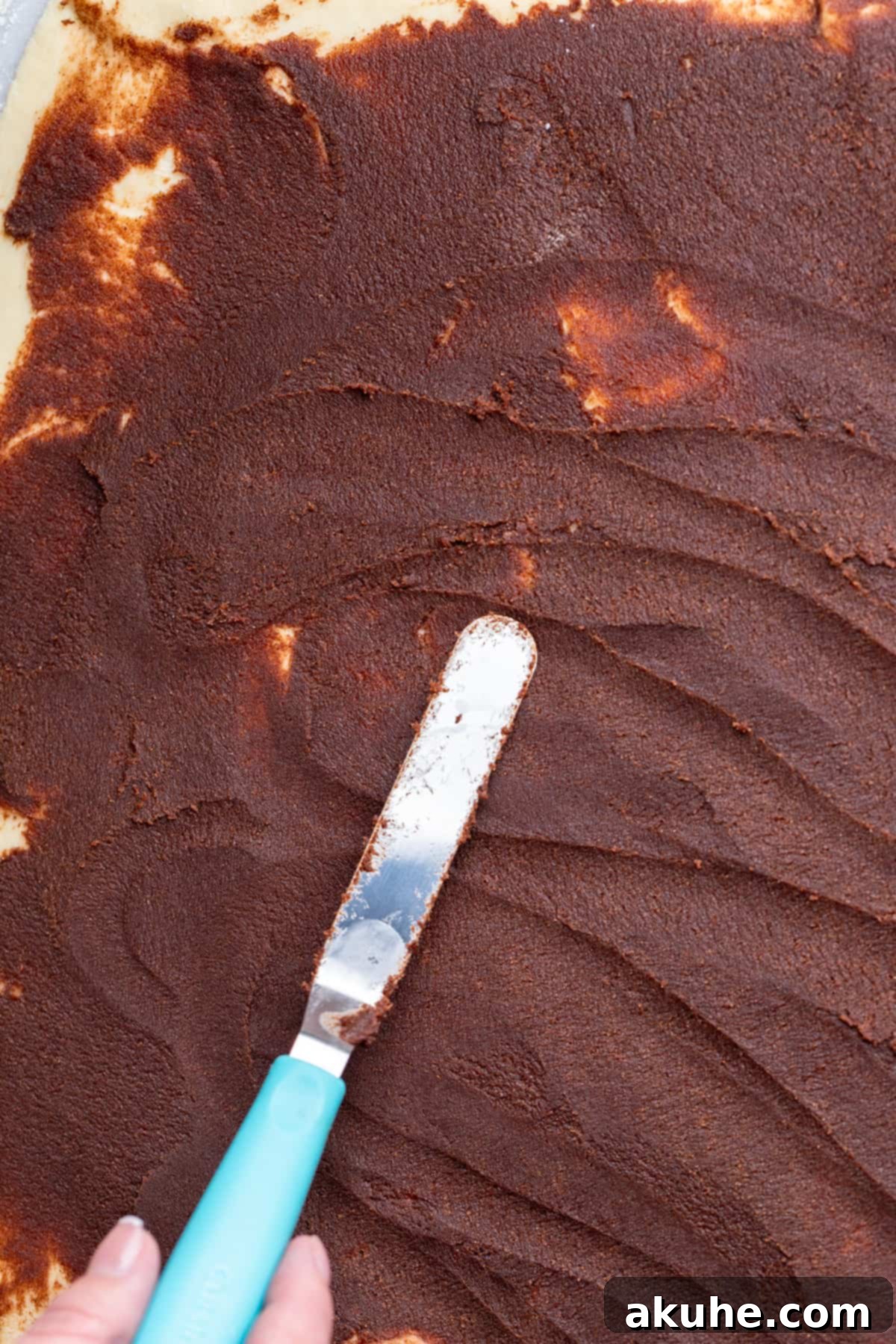 Chocolate Cinnamon Rolls 5 A smooth layer of chocolate cinnamon filling spread evenly over the dough.