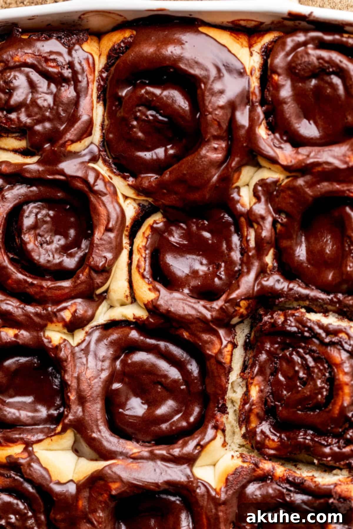 Chocolate Cinnamon Rolls 9 Close-up top view of chocolate cinnamon rolls in the pan, drenched in cream cheese icing.