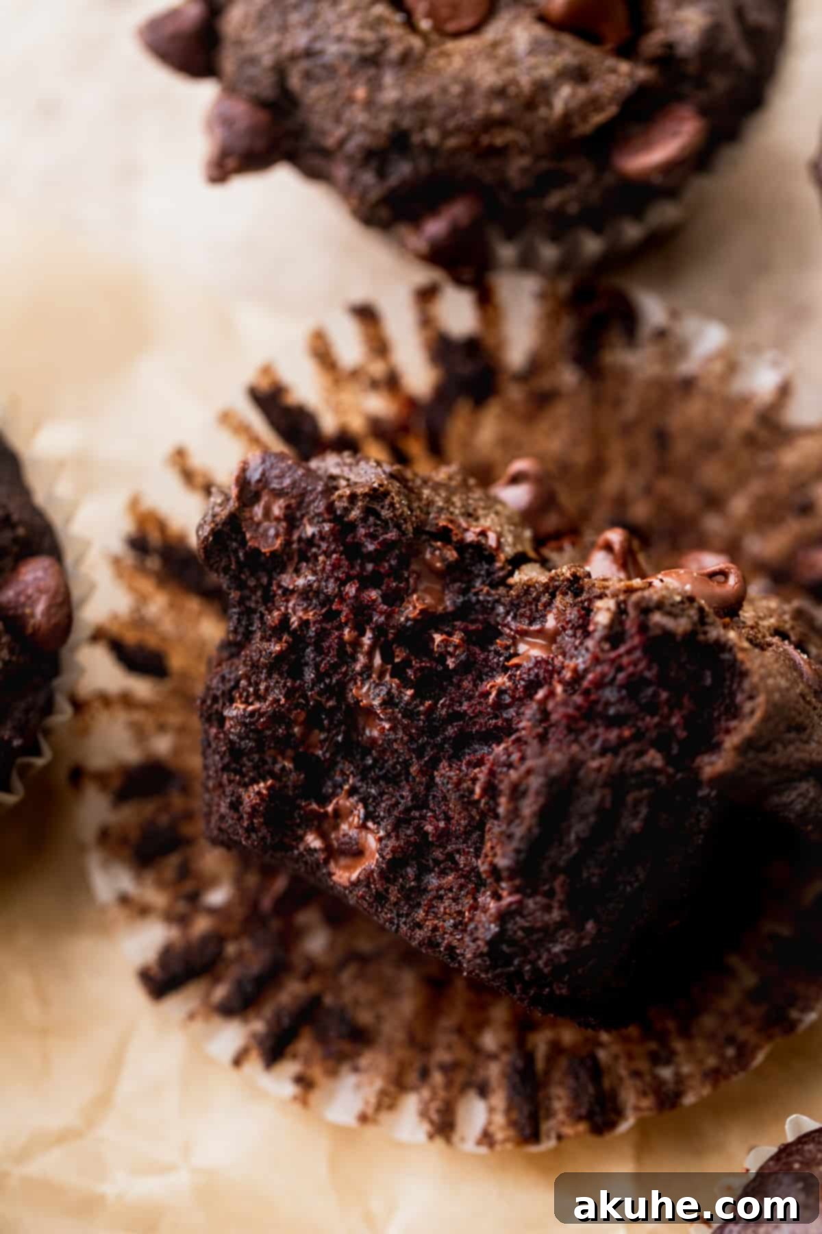 Decadent Triple Chocolate Muffins 8 A bite missing from triple chocolate muffins.