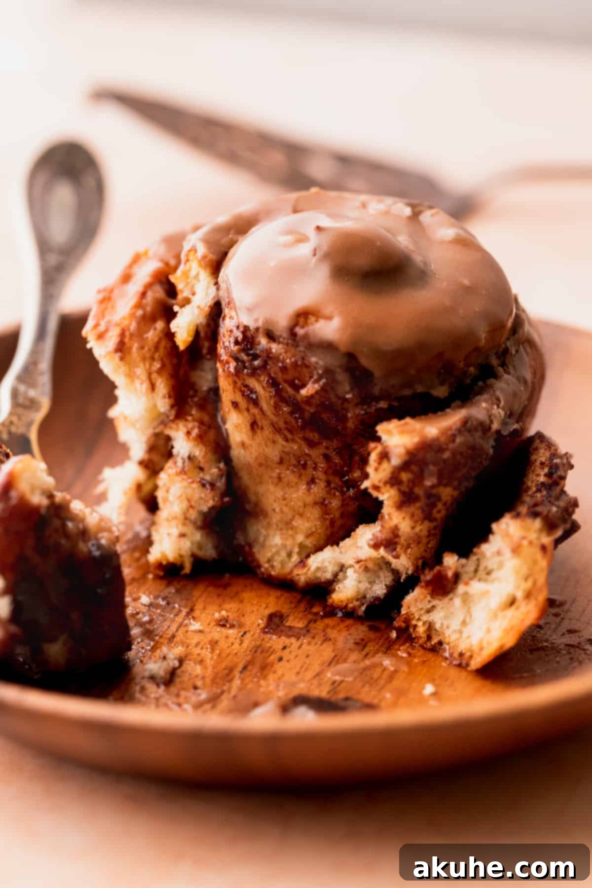 A single Nutella roll on a plate, cut to reveal the gooey chocolate-hazelnut swirls inside.