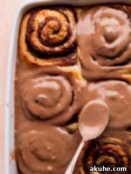 Spreading Nutella icing on top of the Nutella rolls.