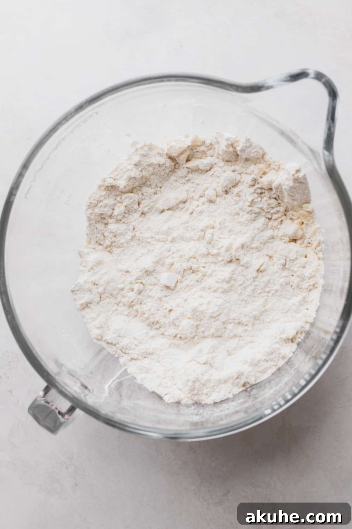 Dry ingredients in a glass bowl, prepared for mixing.