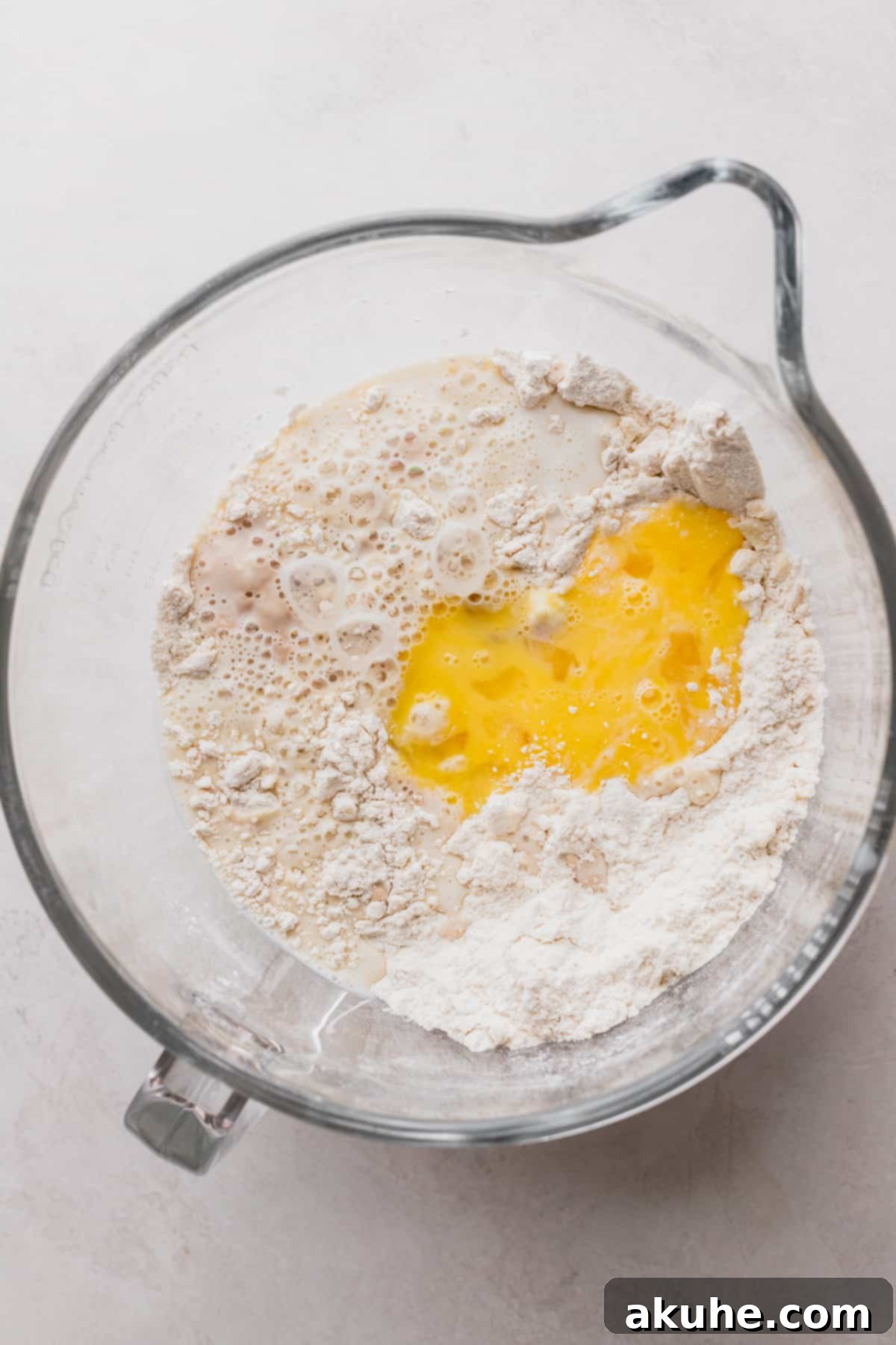 Wet ingredients added to dry mixture, ready for kneading.