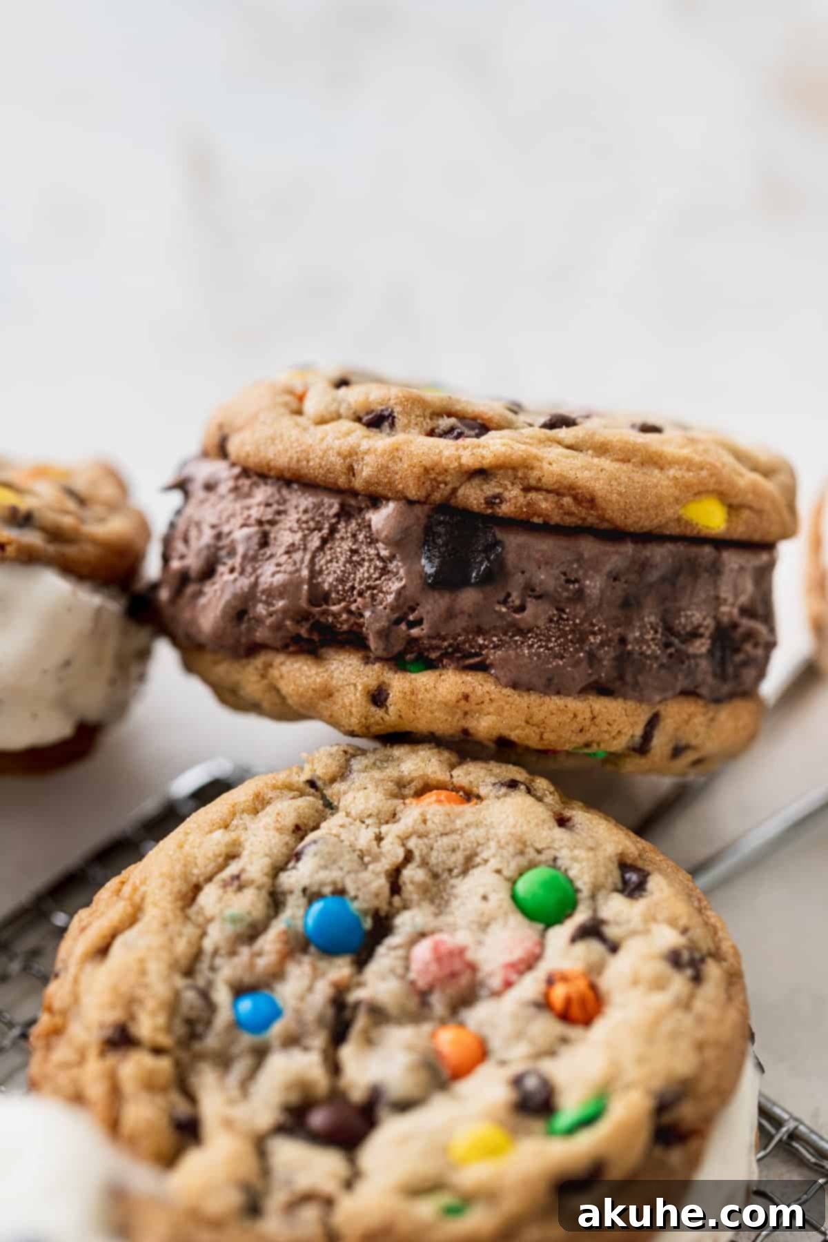 A delicious M&M cookie ice cream sandwich, showcasing the soft cookie texture and a generous layer of chocolate ice cream, presented on its side.