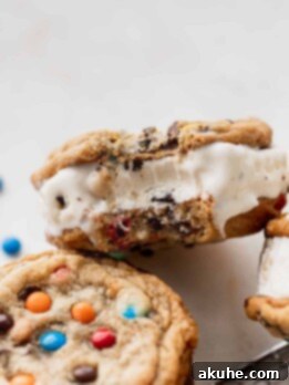 Bite missing from m&m cookie ice cream sandwiches.
