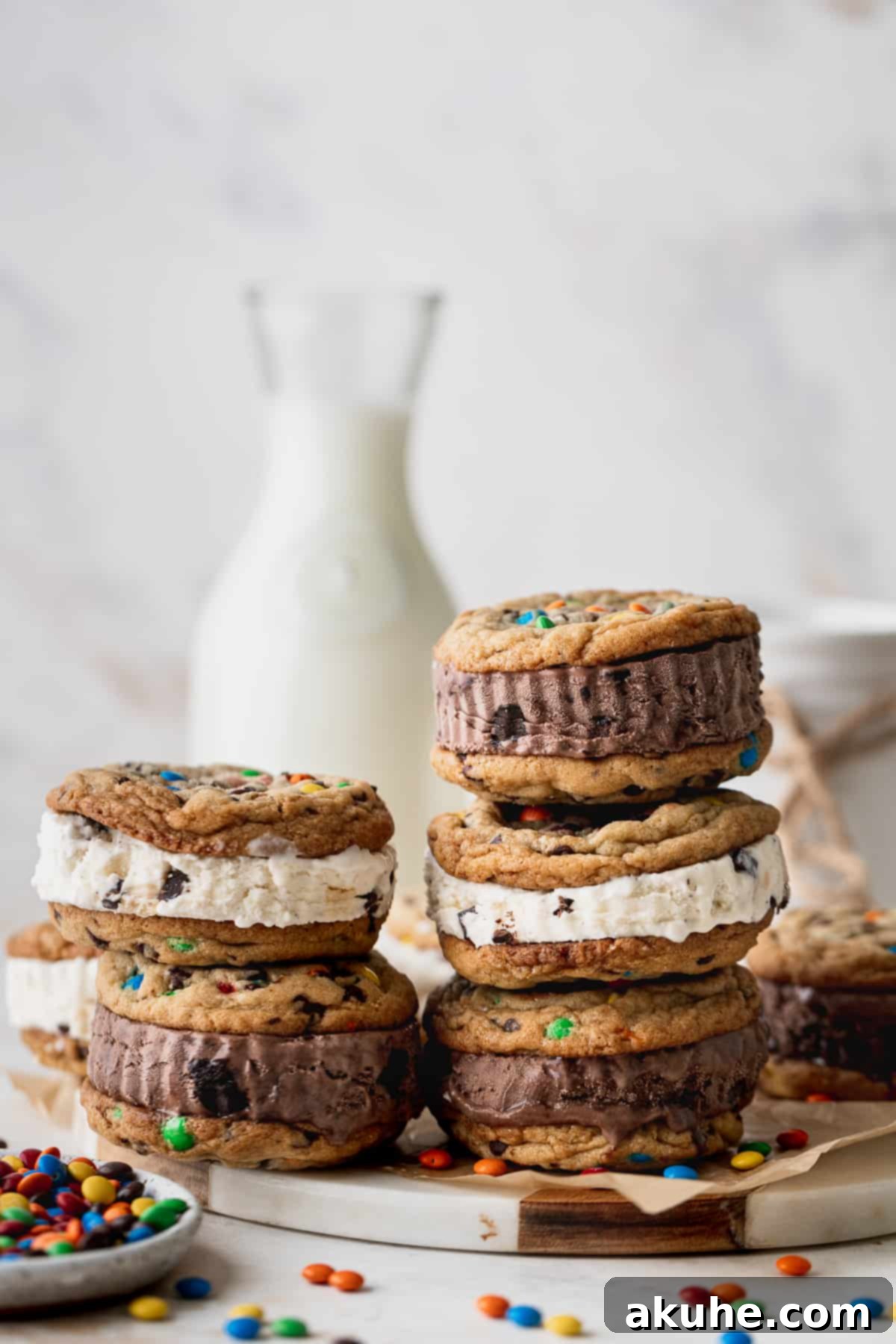 A charming stack of M&M cookies on a white platter, highlighting their vibrant colors and perfect round shapes.