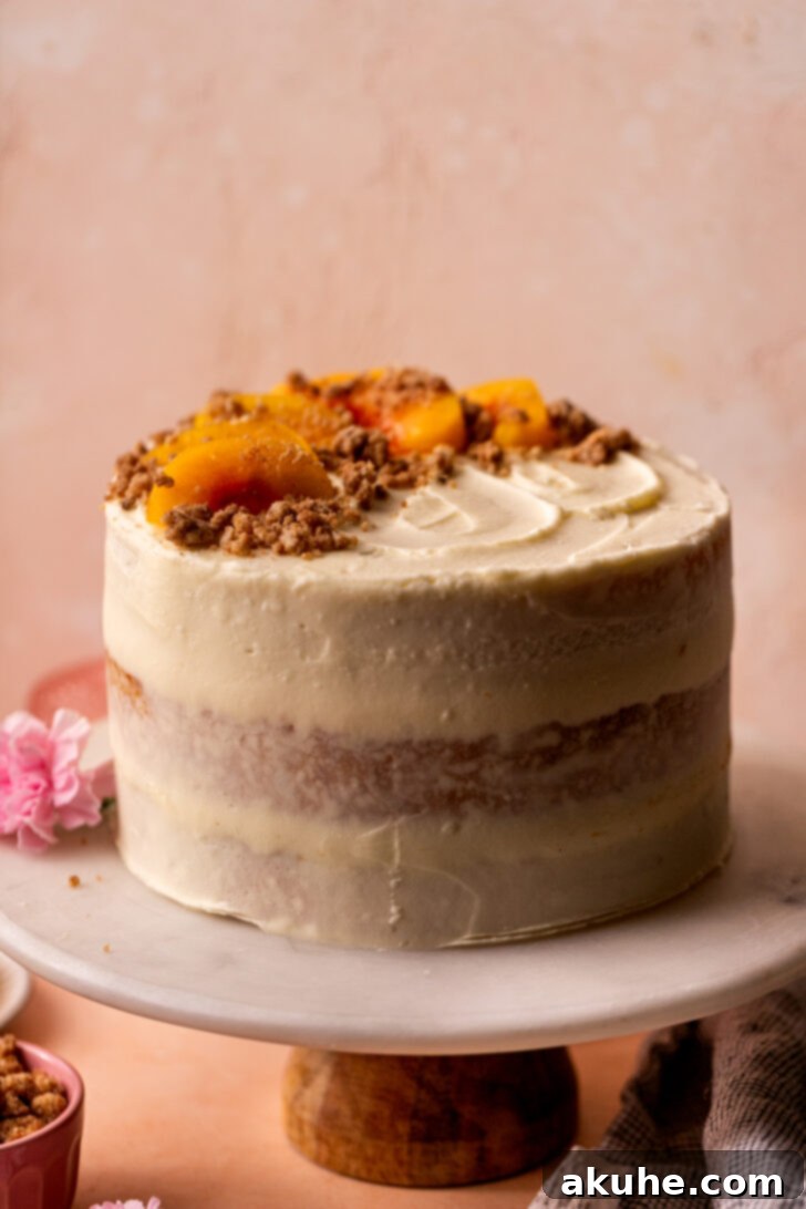Fully decorated Peach Cobbler Cake on an elegant cake stand.