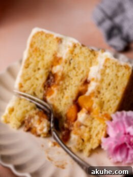 Fork inserted into the peach cobbler cake.