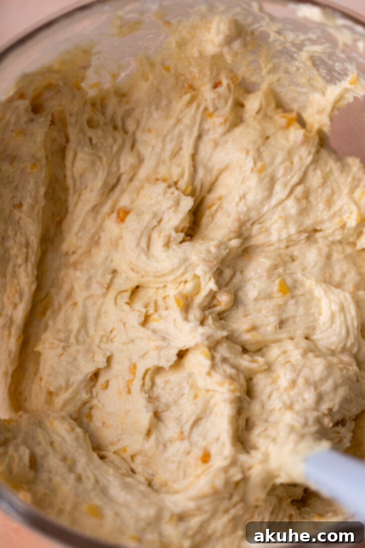 Thick cake batter in a mixing bowl, ready for baking.