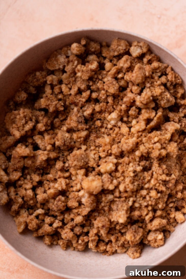 Golden-brown cinnamon crumble in a bowl, highlighting its crunchy texture.