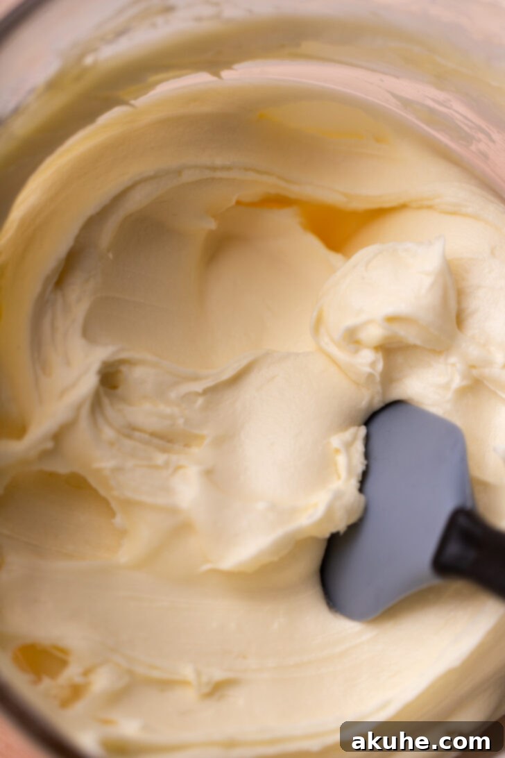 Smooth and creamy cream cheese frosting in a bowl.