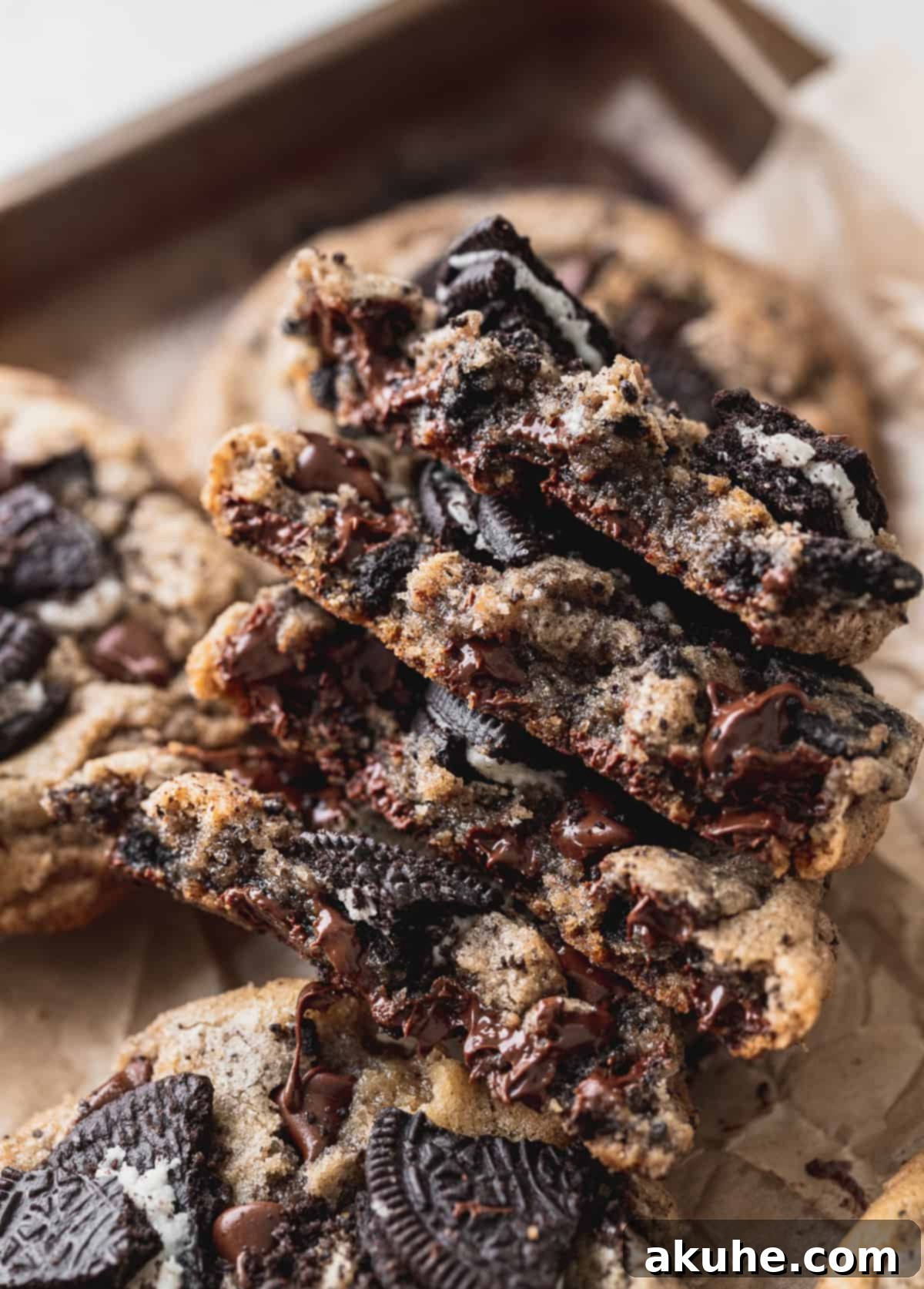 Decadent Oreo Chocolate Chip Cookies 9 The cross-section of a soft, gooey Oreo chocolate chip cookie, showing the melted chocolate and Oreo pieces.