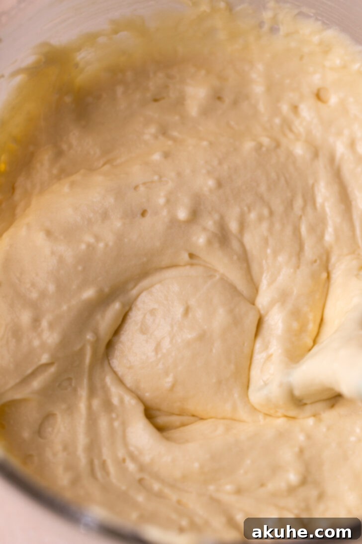 Classic Yellow Cake 5 A mixing bowl holding perfectly smooth yellow cake batter, ready to be divided and spread into prepared cake pans.