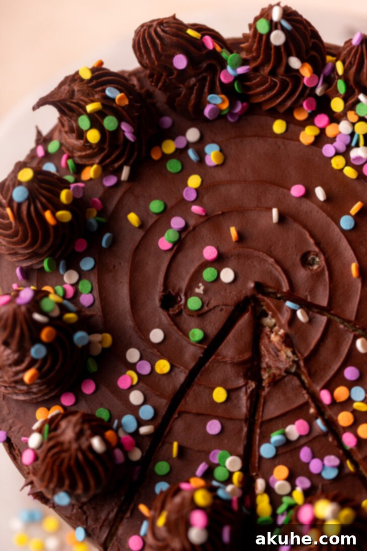 Classic Yellow Cake 9 The top of a beautifully frosted yellow cake, adorned with elegantly piped dollops of chocolate cream cheese frosting and a scattering of colorful sprinkles.