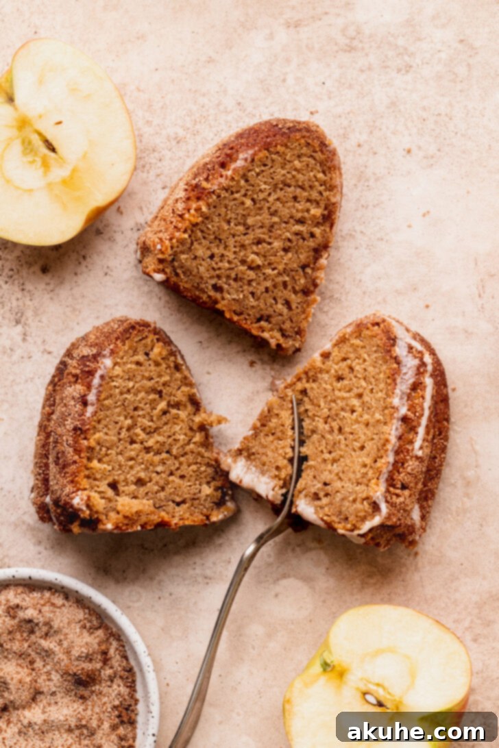 Spiced Apple Cider Donut Cake 10 Three perfectly cut slices of apple cider donut cake, stacked and presented beautifully, highlighting their appealing texture.