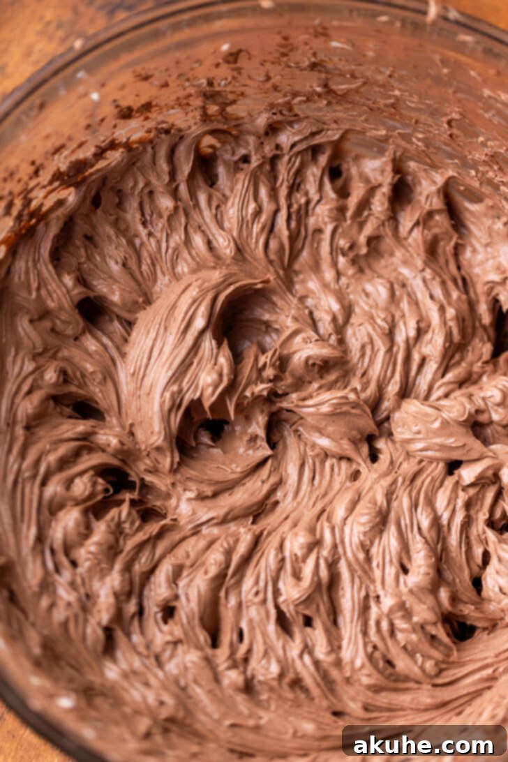 Cheesecake batter before whipped cream is added, appearing smooth and dark chocolate brown.