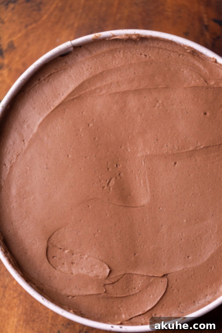 Smooth chocolate cheesecake batter evenly spread over the Oreo crust in a springform pan.