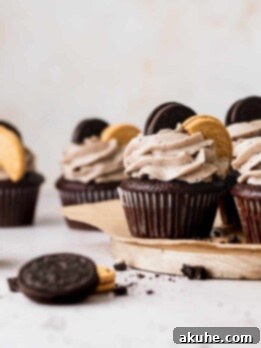Decadent Oreo Cupcakes 11 Delicious Oreo cupcakes ready to be served on a wooden board.