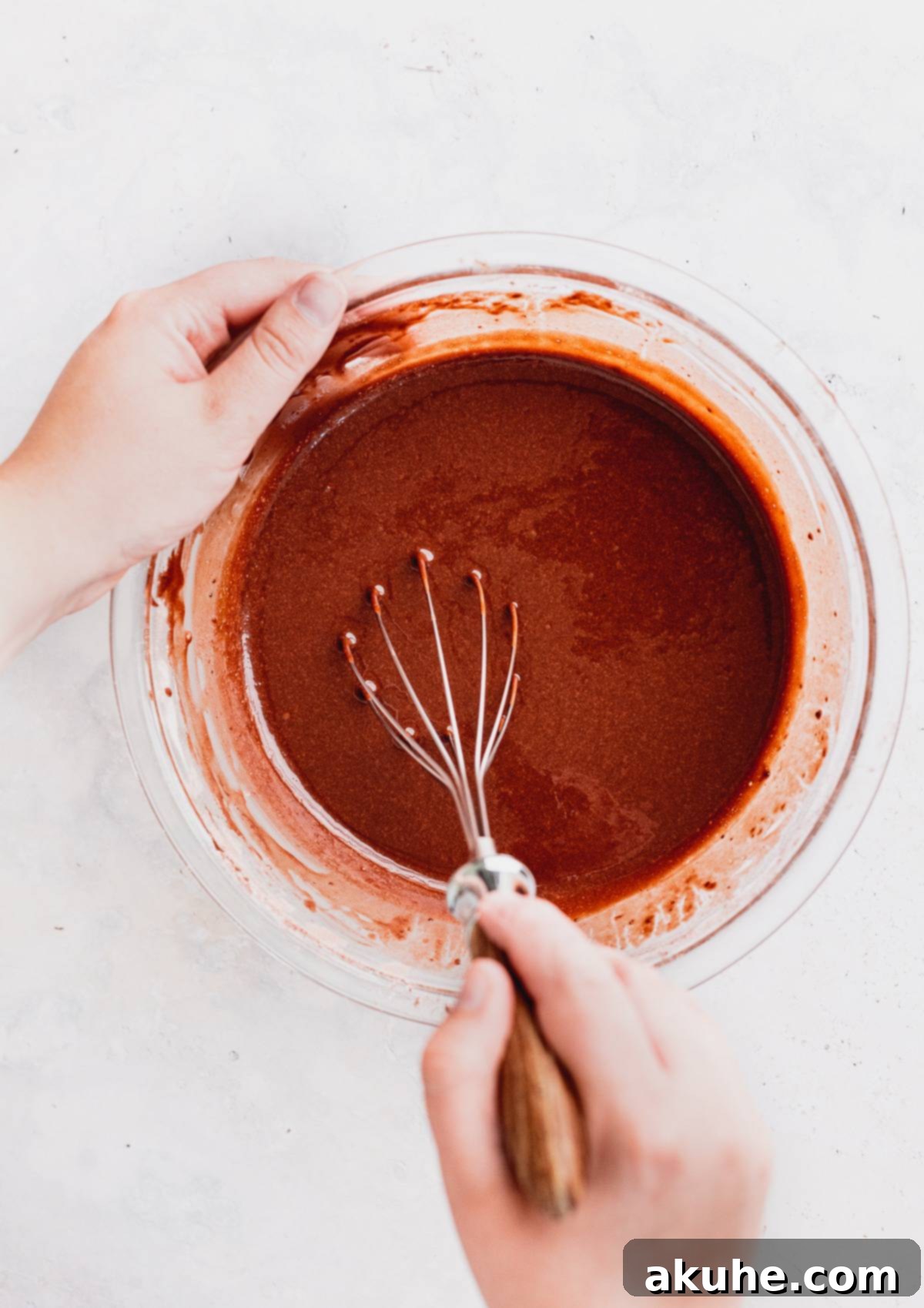 Decadent Oreo Cupcakes 5 Rich chocolate cupcake batter in a clear glass mixing bowl, ready for baking.