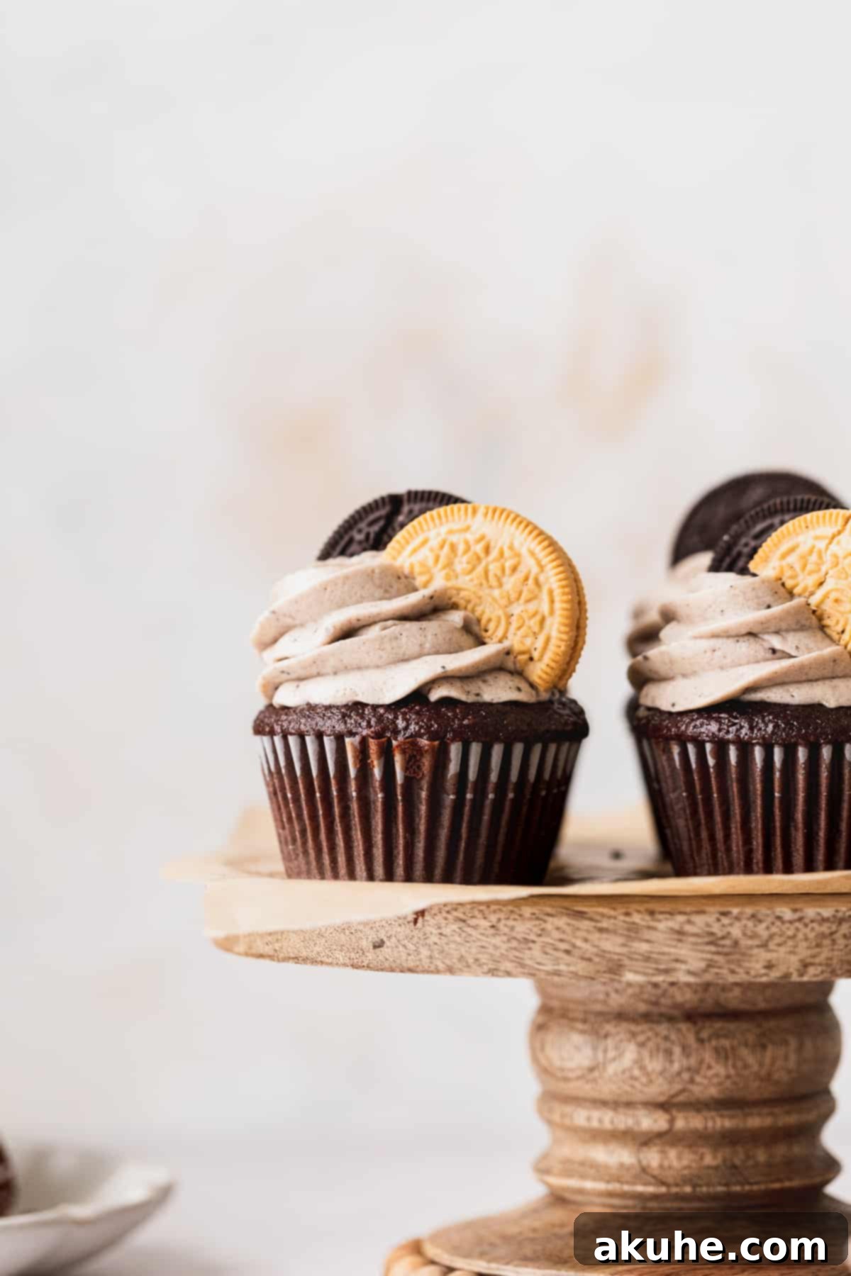 Decadent Oreo Cupcakes 9 A collection of beautifully frosted Oreo cupcakes artfully arranged on an elegant cake stand.