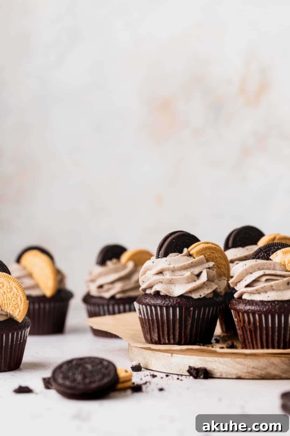 Decadent Oreo Cupcakes 10 A stunning arrangement of Oreo cupcakes on a wooden board, showcasing their detailed frosting and cookie embellishments.