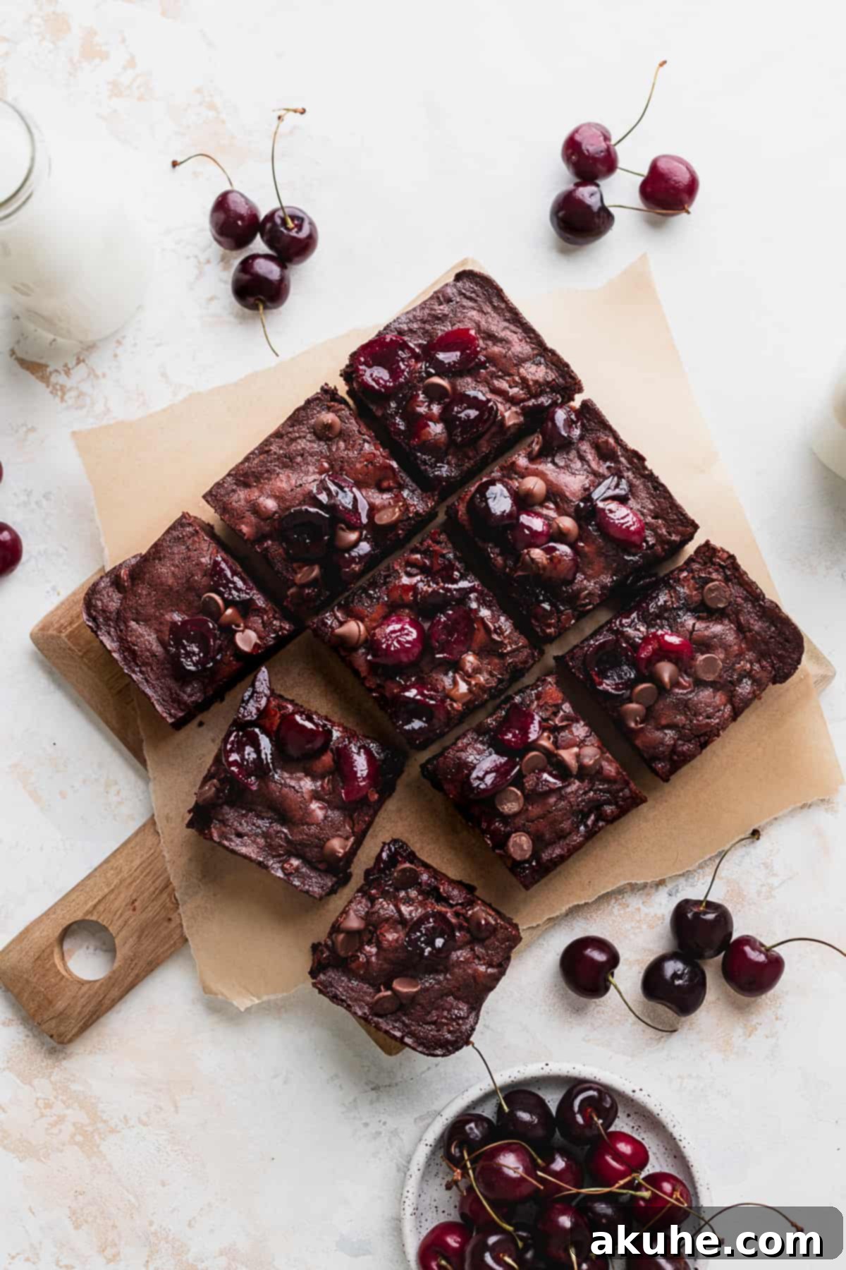 Deep-Roasted Cherry Chocolate Brownies 9 Fudgy roasted chocolate cherry brownies on a cutting board, ready to be served.