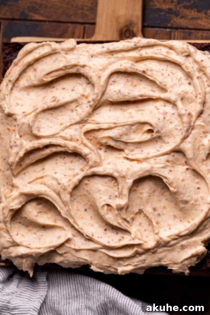 Decadent Butterfinger Crunch Cake 11 Butterfinger cream cheese frosting smoothly spread over the peanut butter-filled cake, with crushed Butterfingers on top.