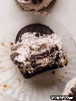 Bite-Sized Oreo Cheesecakes 11 A bite missing from mini Oreo cheesecakes, showing the rich filling and creamy topping.