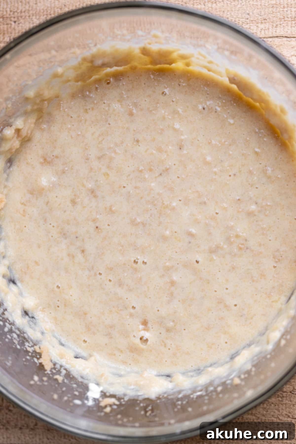 One-Bowl Banana Cake 4 Wet ingredients expertly mixed in a large glass bowl, ready for the dry components.