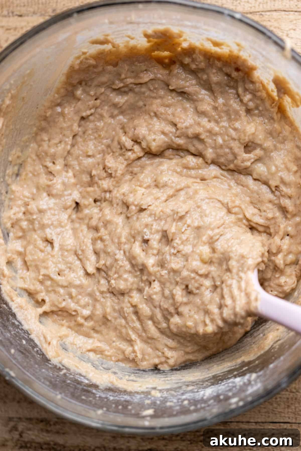 One-Bowl Banana Cake 5 Smooth and creamy banana cake batter in a glass bowl, showcasing its rich texture.