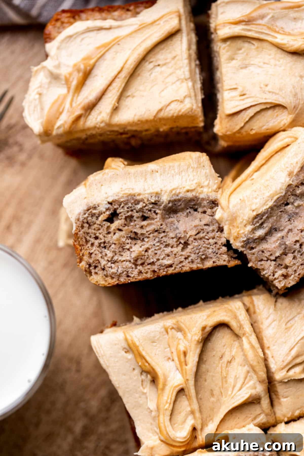 One-Bowl Banana Cake 8 A close-up top view of the fully frosted banana snack cake, showing the smooth peanut butter topping.