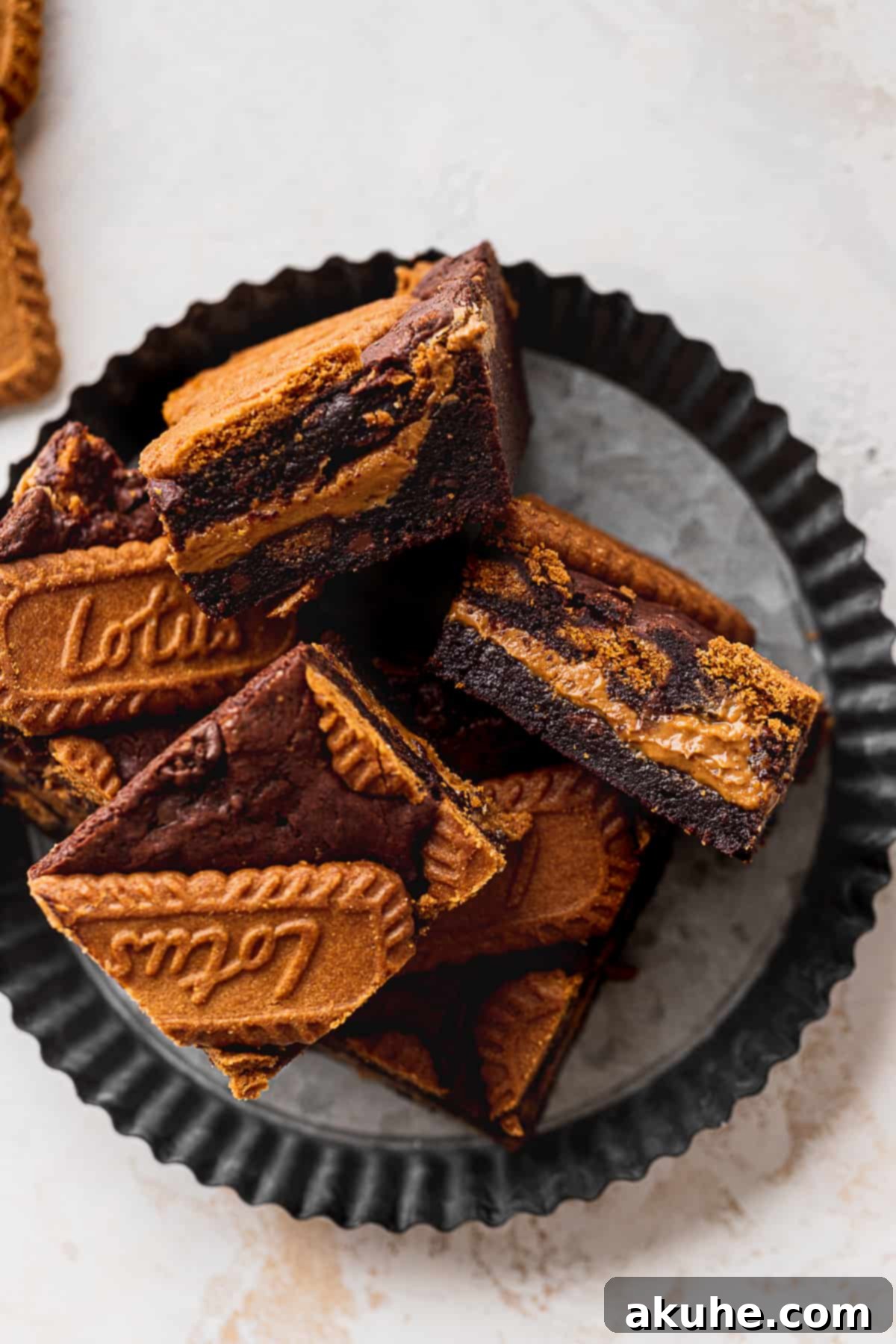 Fudgy Biscoff Swirl Brownies 11 Biscoff brownies on a plate.