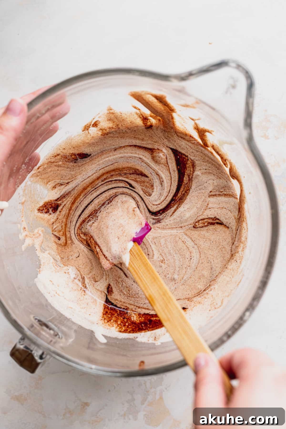 Fudgy Biscoff Swirl Brownies 5 Mixing brownie batter in glass bowl.