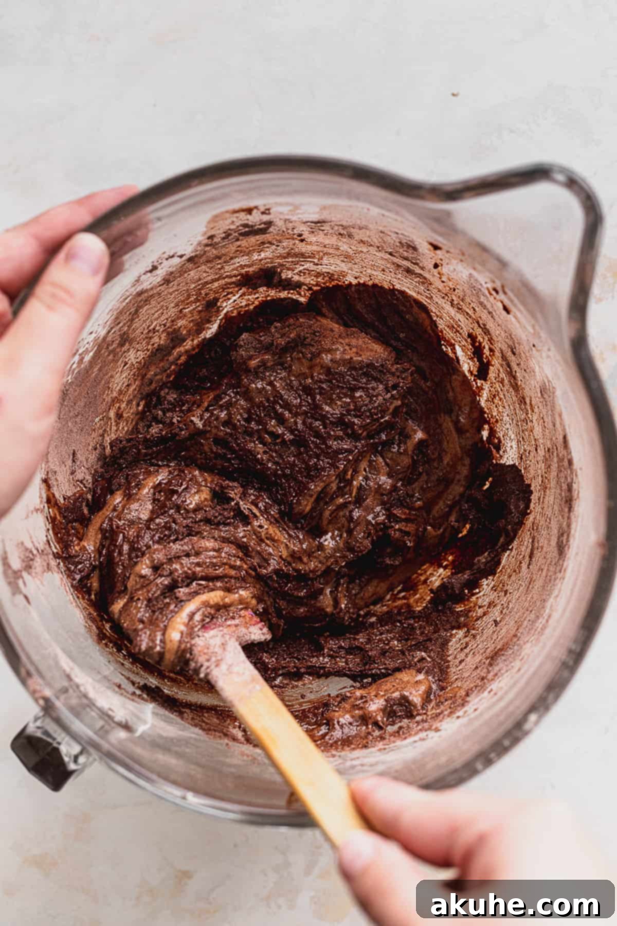 Fudgy Biscoff Swirl Brownies 6 Mixing brownie batter in glass bowl.