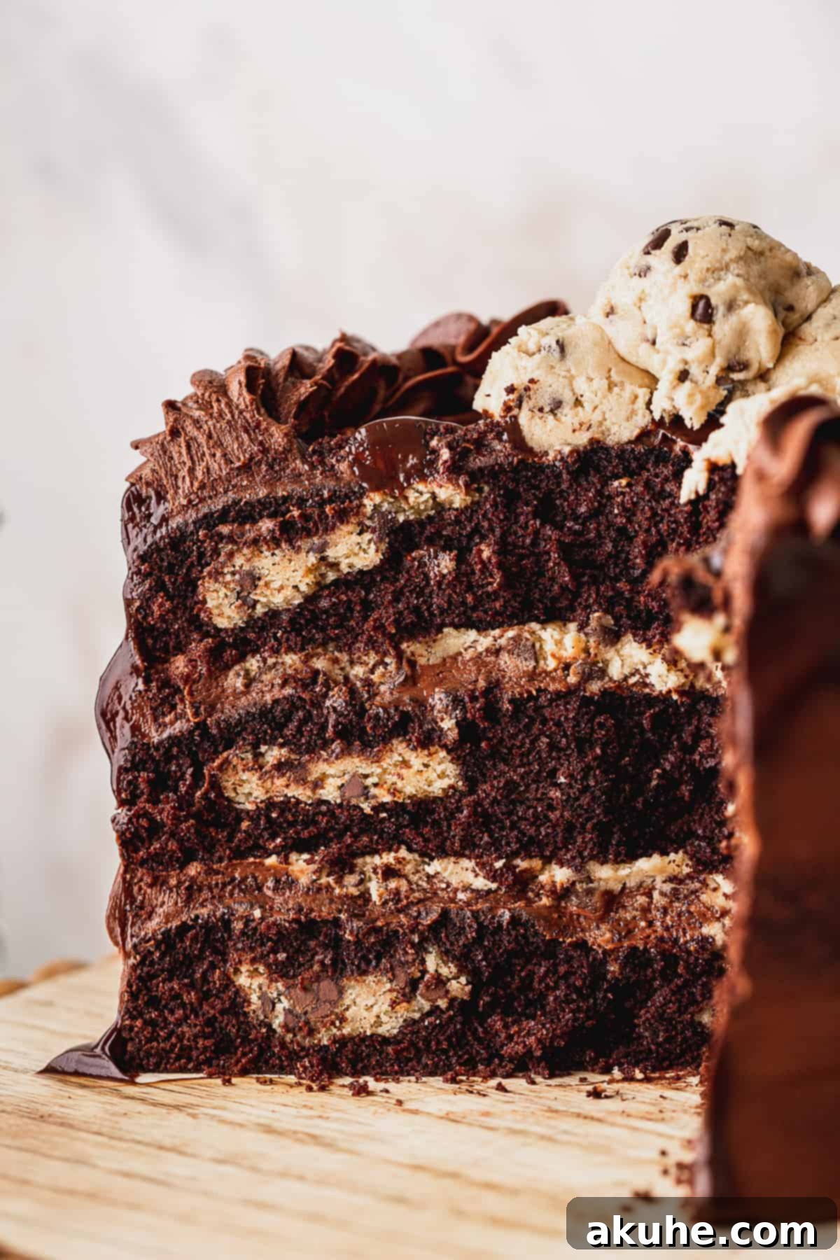 Decadent Cookie Brownie Cake 3 Close-up internal view of a slice of chocolate brownie cookie cake, showing layers of brownie, cookie dough, and frosting.