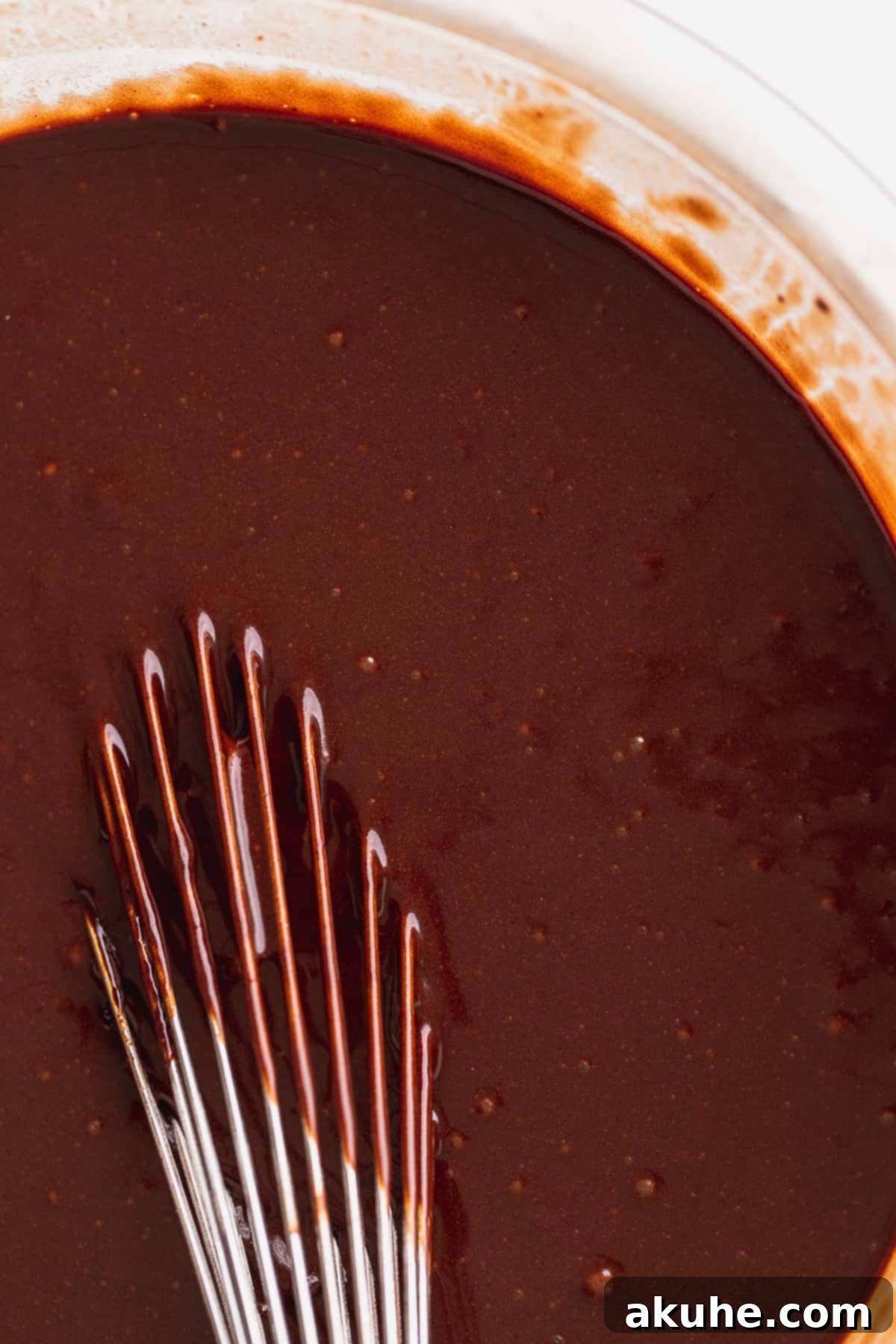 Decadent Cookie Brownie Cake 8 Close-up of rich, dark chocolate cake batter.